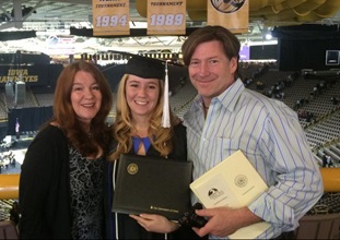 Nicky Fish with parents at graduation ceremony