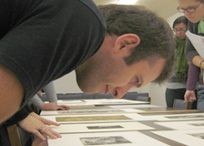Person leaning in close to look at a print