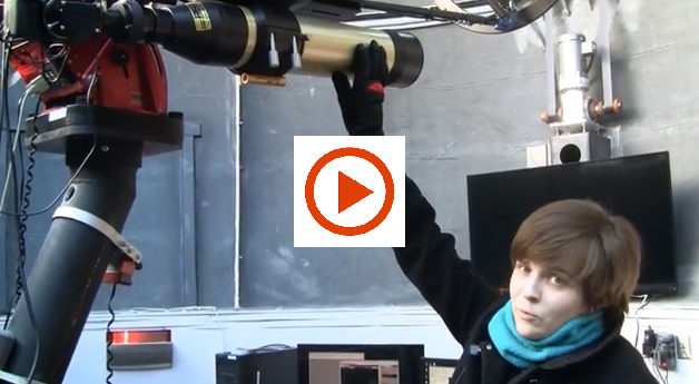 ERin Maier with telescope and play button for video