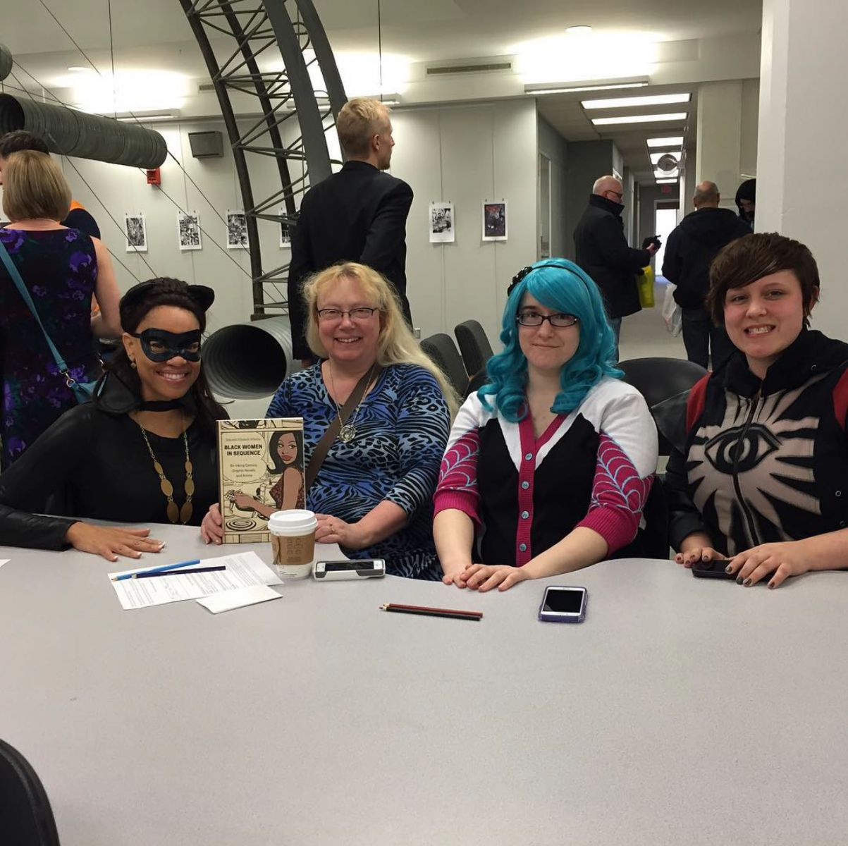 Whaley dressed as Catwoman, sitting next to three women
