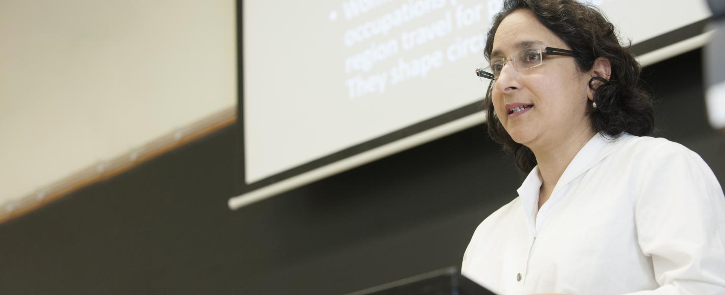 Professor Meena Khandelwal speaking at the front of a classroom.