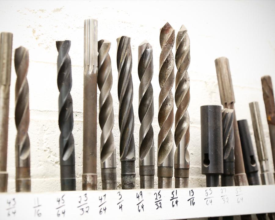 Drills lined up by size, used for machine shop.