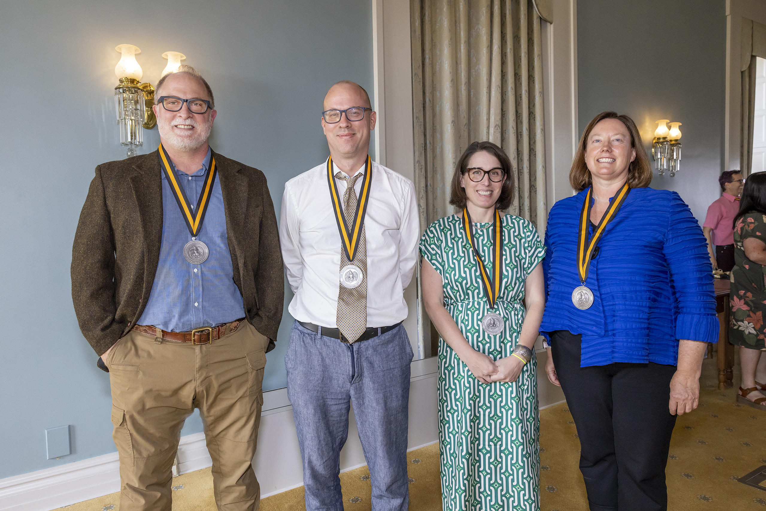 A group shot of the classics professors with medals around their necks