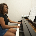 Student plays piano during Iowa Summer Music Camps, hosted by the UI School of Music.  
