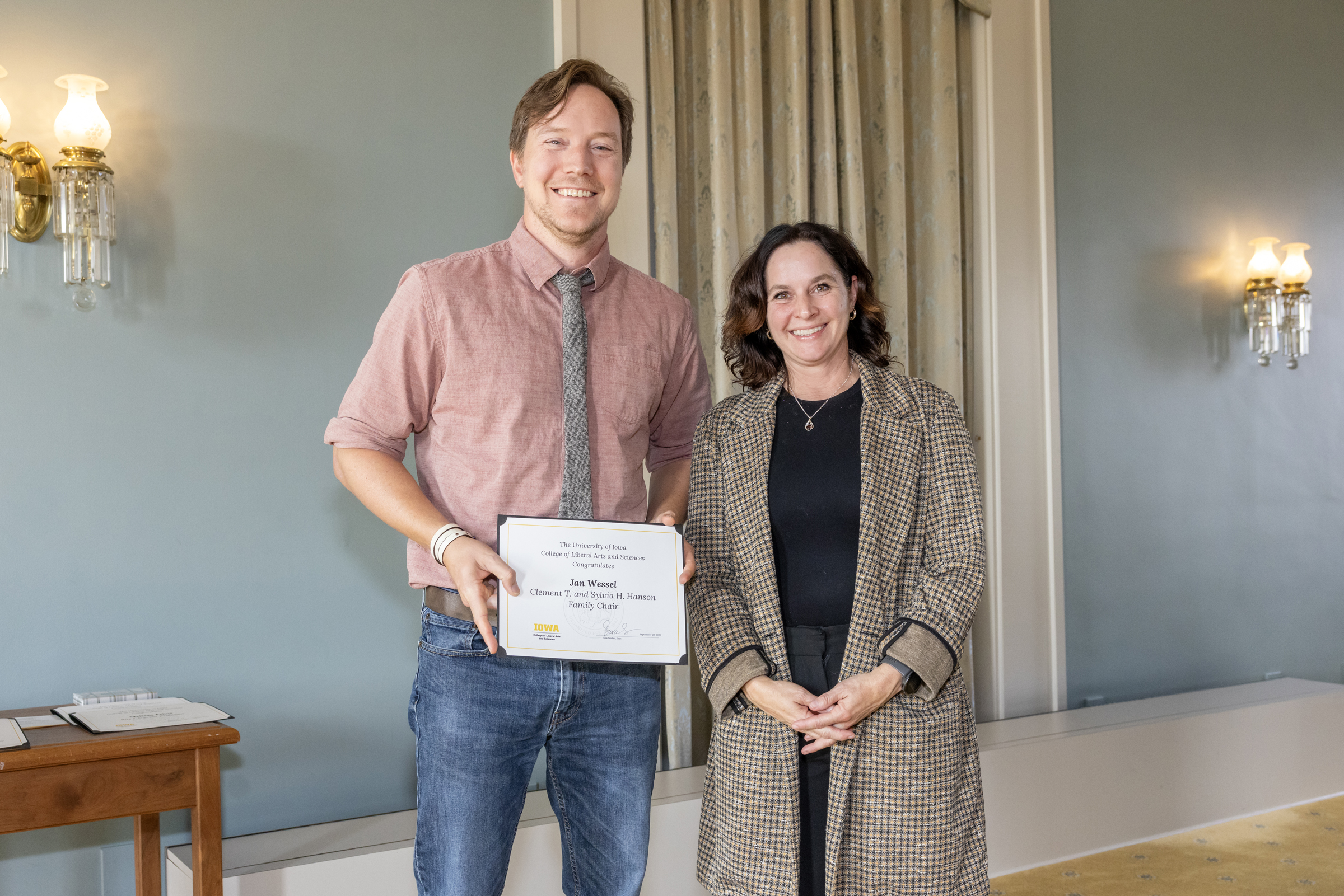Jan Wessel, left, holds certificate and stands next to Dean Sanders, right