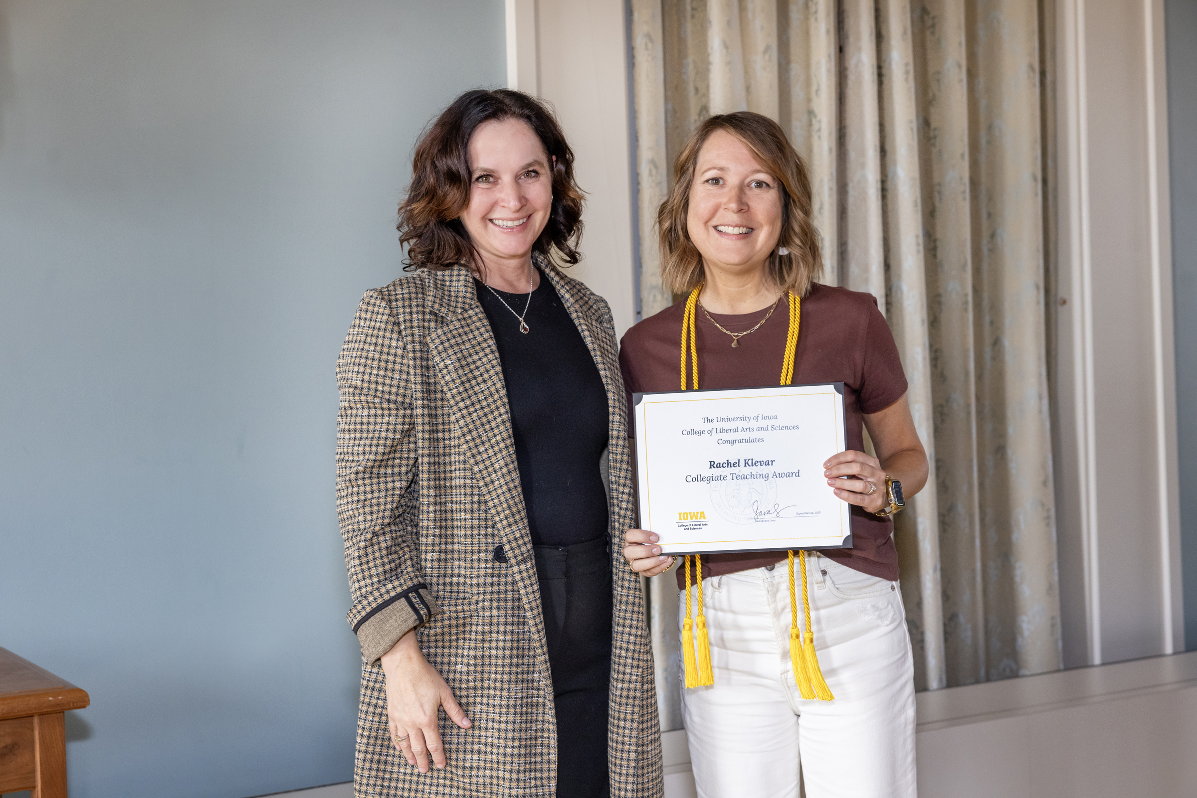 Dean Sara Sanders, left; Rachel Clever, holding certificate, right