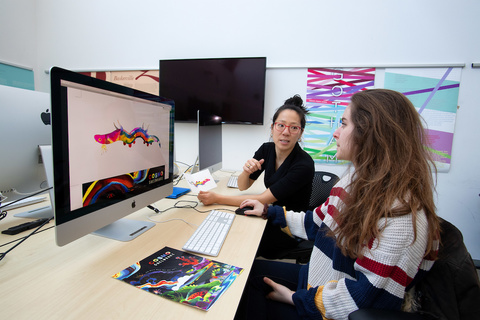 A student works on a project during a graphic design course. 