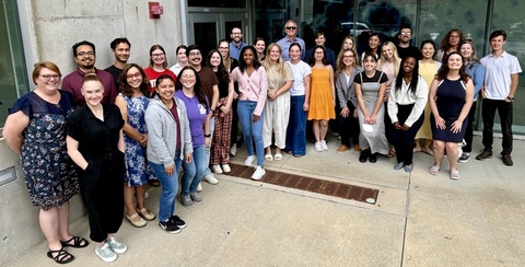 Students and mentors of the Behavioral-Biomedical Interface training program gathered outside a university building.