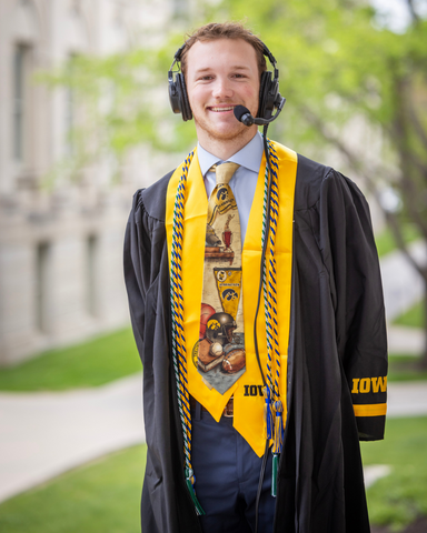 Aidan Wirtz in his Commencement gown, cords, and headset_cropped