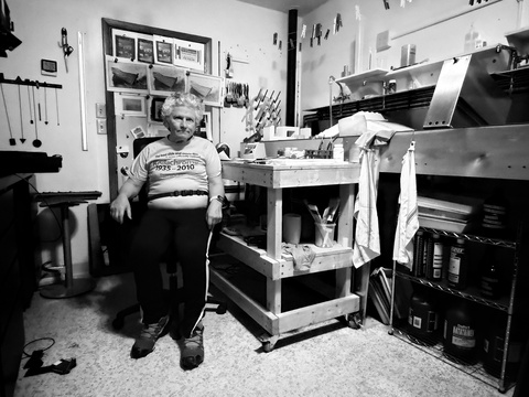 A black and white photo of Johnny Brian in his darkroom
