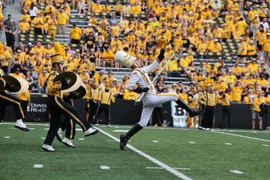 christian frankle performing on the field as drum major with the Hawkeye Marching Band