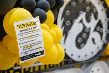 Balloons with a sign on the front that says "Fresh Check Day. Reach out..."