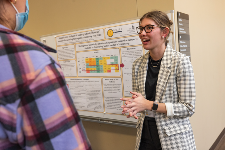 student presenting research at a research fair
