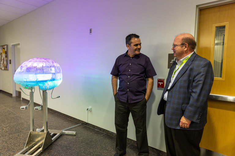 Miller and Ted Abel, Director of the Iowa Neuroscience Institute, celebrate the new installation. Photo: Jeff Hackbarth, UIHC
