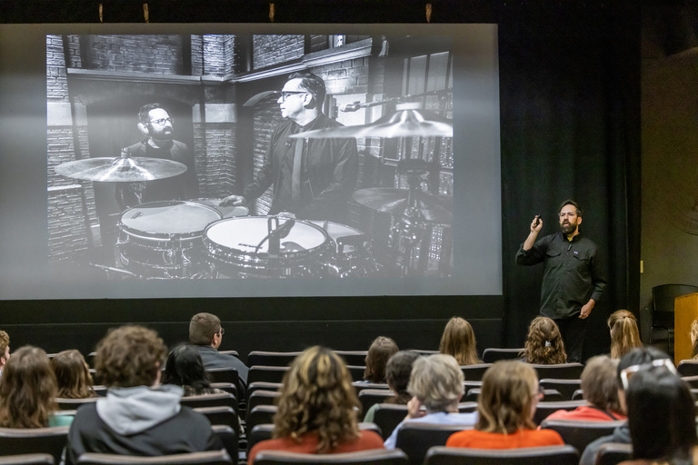 CLAS Alumni Fellow Eric Leiderman urges students to be adaptable, illustrating his success with the tactic by showing a photo of him talking with Fred Armisen, head of the "Late Night with Seth Myers" house band