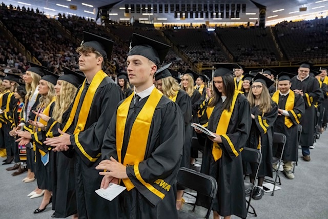 Students standing at Commencement ceremony