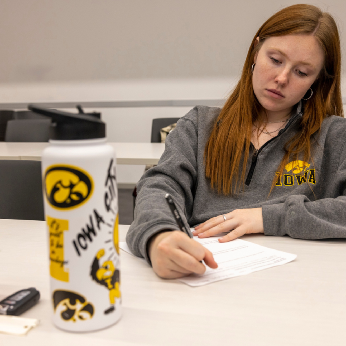 A student in hawkeye gear working hard at studying