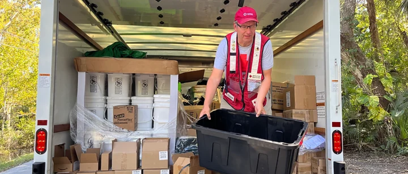 George McCrory in the back of a truck volunteering in Florida after Hurricane Ian