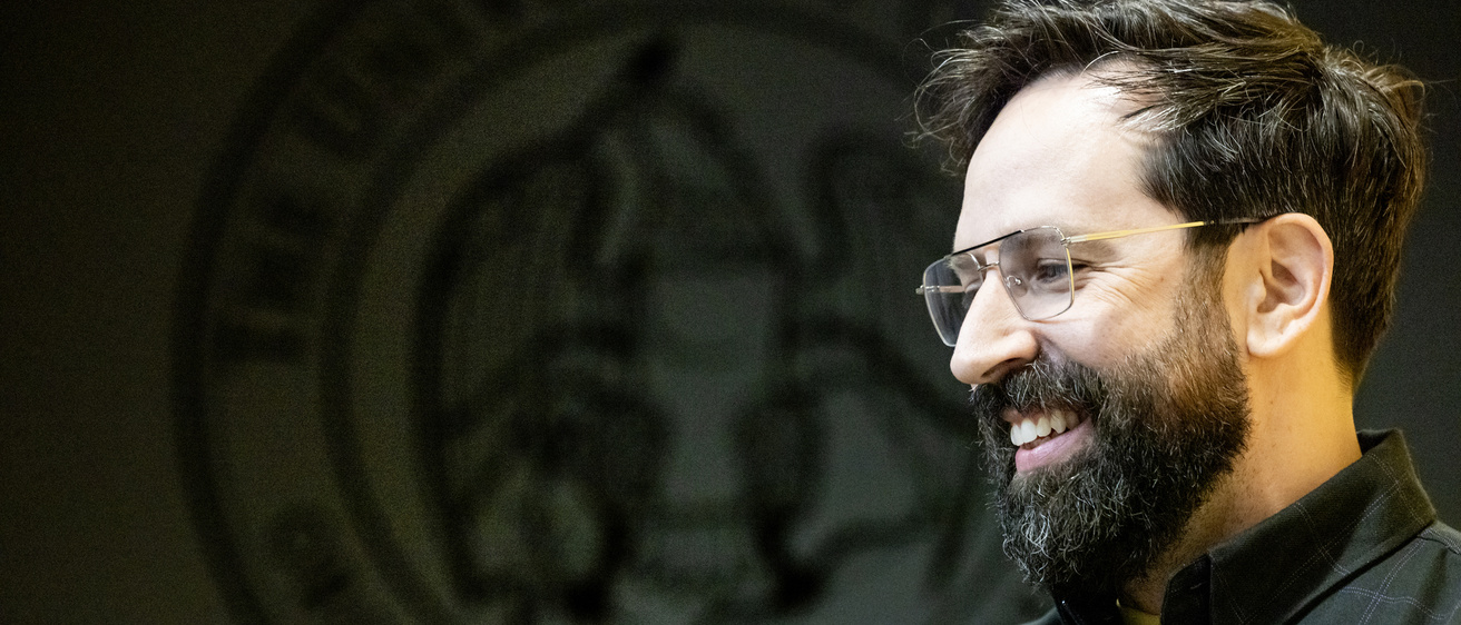 Eric Leiderman's smiling profile against a dark background