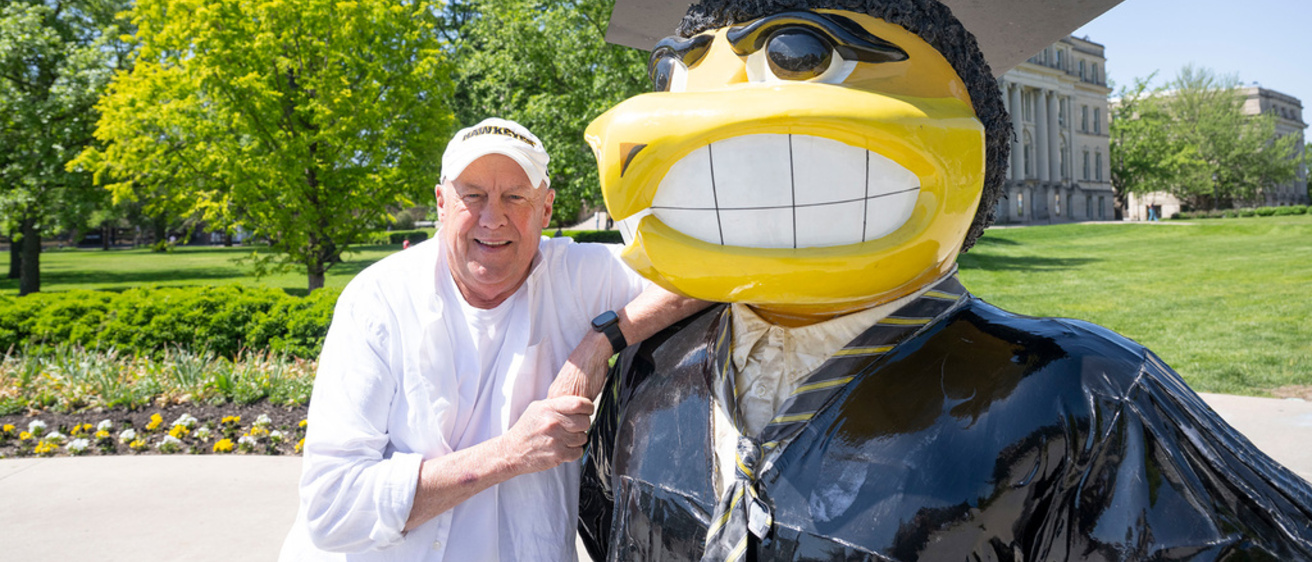 Tim Dickson with Herky grad statue