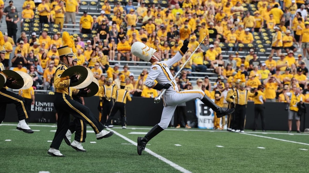 christian frankle performing on the field as drum major with the Hawkeye Marching Band