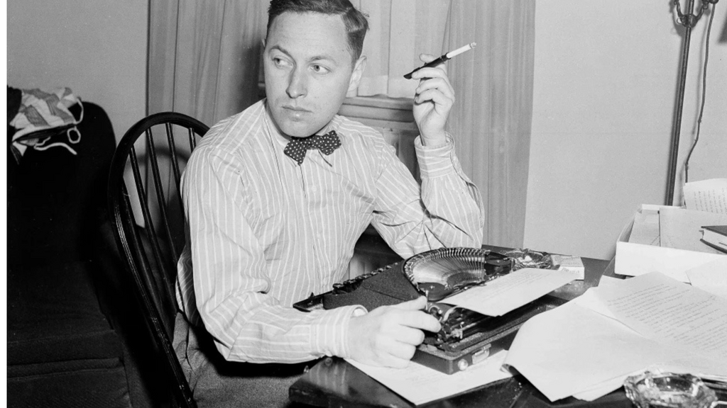 Black and white photo of Tennessee Wiliiams writing and smoking a cigarette