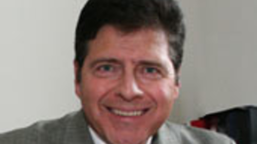 Raul Curto at a desk with pen in hand
