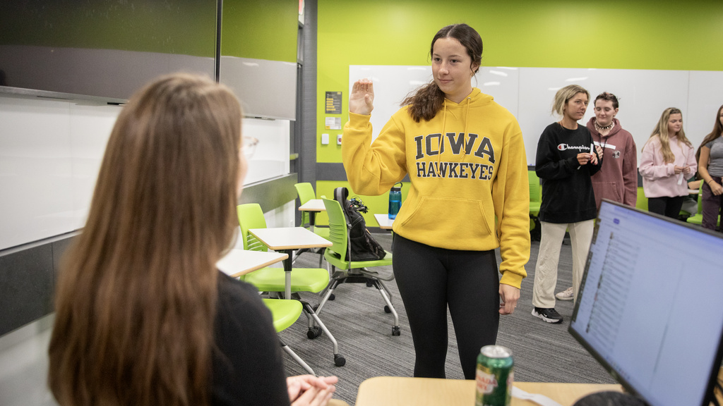 Student signing in an American Sign Language class