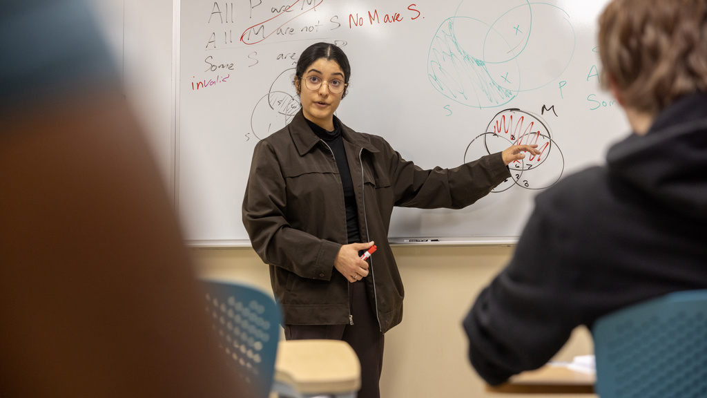 Debate class professor at the whiteboard