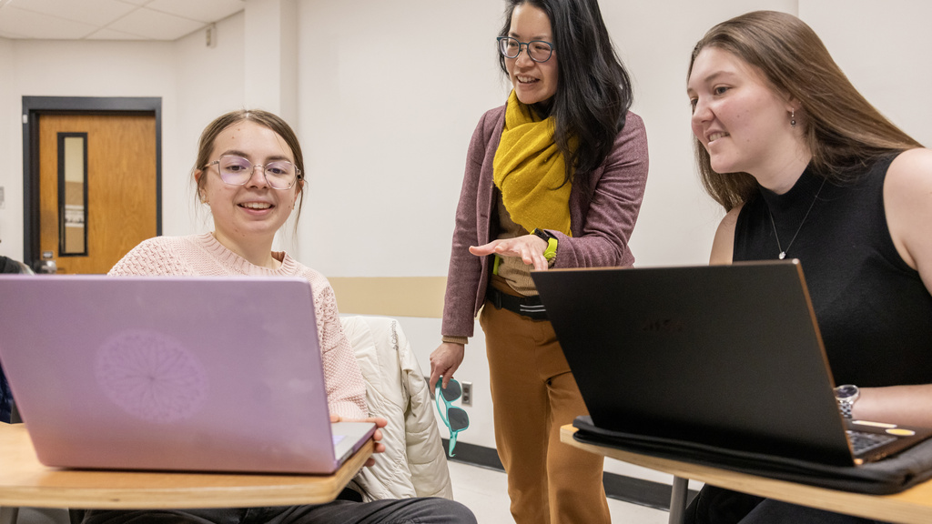students working in samll group with faculty memberin translation class