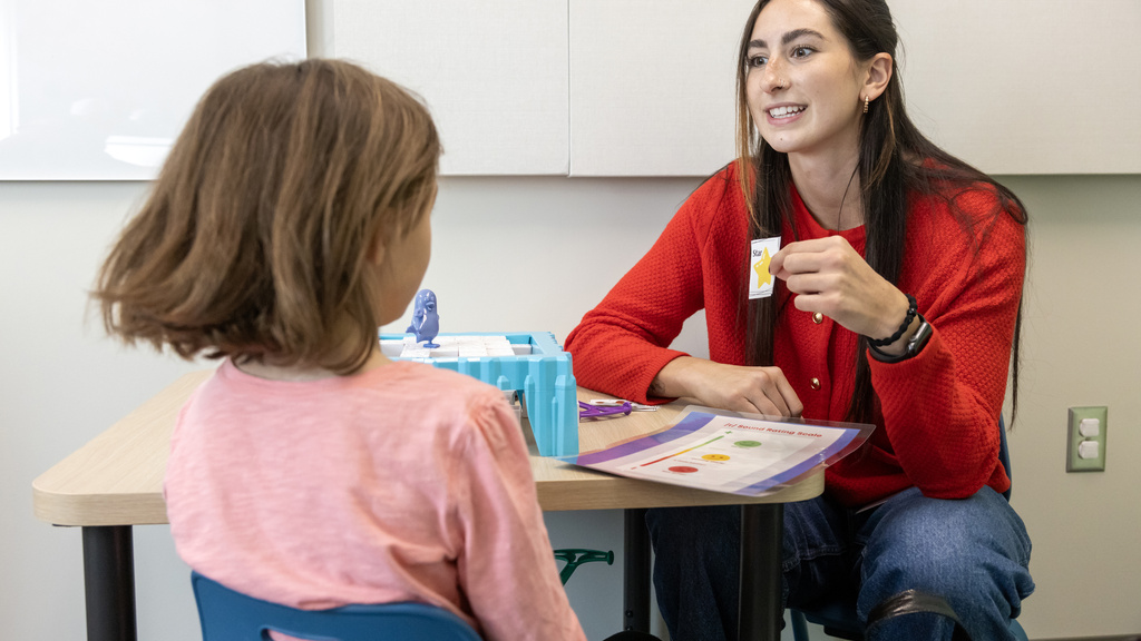 speech pathology student working with a child in clinic