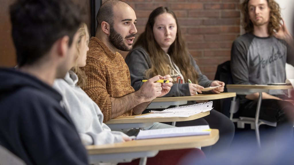 students in philosophy class debating