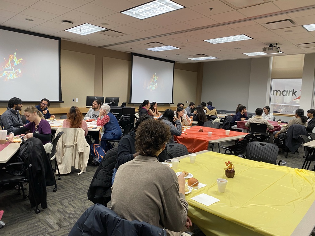 University of Iowa students, volunteers, staff, and faculty members enjoy a fall meal.