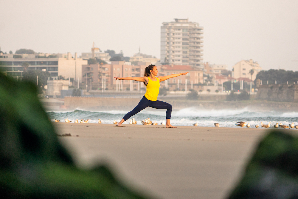 Lily Allen-Dueñas does yoga on the beach.