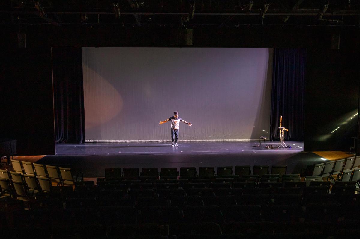 A performer dances on the Space Place Theater stage.