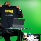 Stephen A. Smith holds up an Iowa journalism shirt
