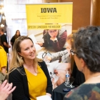 Beth Walker speaks with a lawmaker during Hawkeye Caucus 