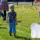 A child participates with a butterfly net during the third annual BioBlitz